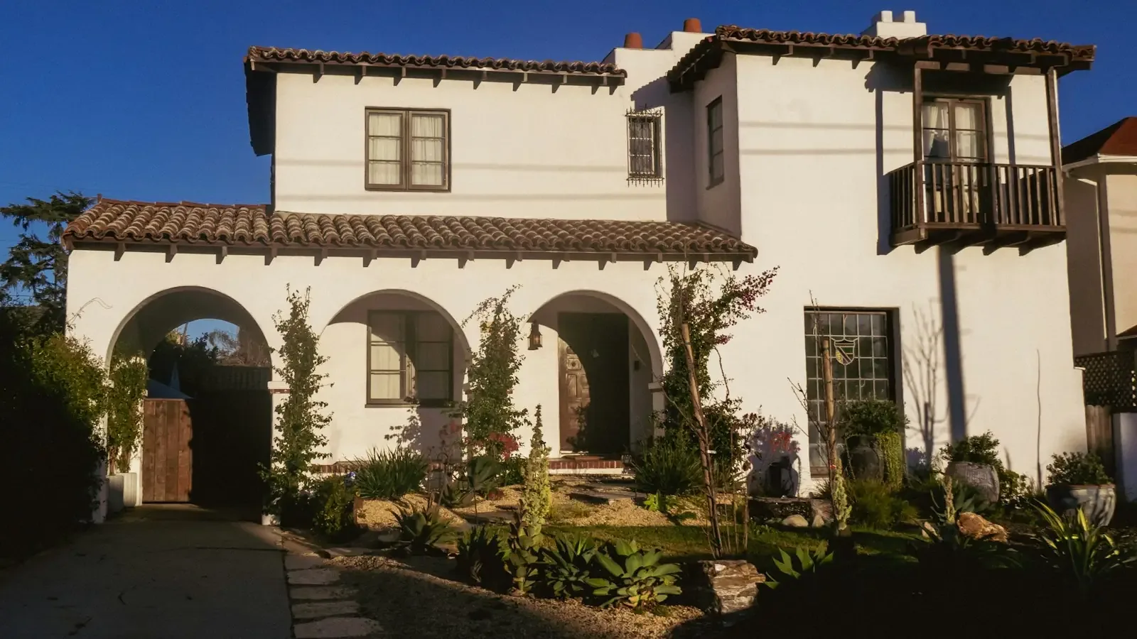 A two-story Spanish Revival house with arched openings in an older part of Tustin